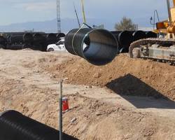 wastewater pipes installation construction site heavy machinery، من إنشاء الذكاء الاصطناعي