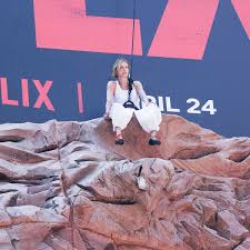 Charlize Theron takes ‘Apex’ promo to new heights with wall-climbing stunt in NYC