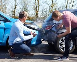 Image of person looking at a car accident