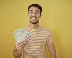 Image of someone holding up a wad of cash with a triumphant expression