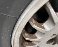 Image of car wheel with stubborn brake dust and tar