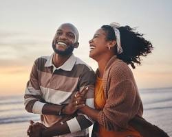 Image of happy couple laughing and holding hands