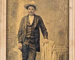 Image of young John Wesley Hardin, a boyish face with a hint of defiance, standing with a rifle in his hand