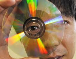 Dr James Chon of the Swinburne University of Technology, holds up a DVD containing new technology that can store data in five dimensions. Photo: AFP - jameschon1_wideweb__470x365,0