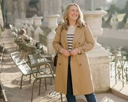 Image of Woman in Breton top, jeans, and trench coat