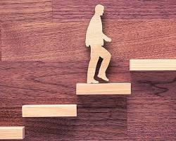 Image of person standing in front of a bright future with insurance policies as building blocks