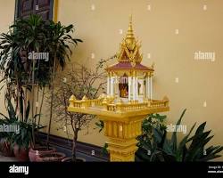 A traditional and ornate Khmer spirit house with offerings in Cambodia
