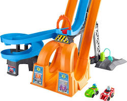 Зображення: child racing Hot Wheels cars on a complex track