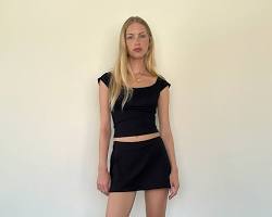 Image of young woman wearing a short Aline skirt with a crop top