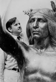 William Gordon Huff stands next to his statue of Chief Solano, which is now in front of the Solano County Events Center. (Courtesy photo) - sculptingSolanostatue-698x1024