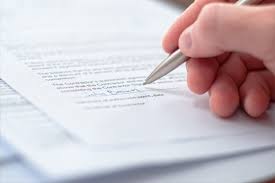 Person reviewing and signing a document