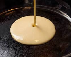 Gambar Pouring the batter onto the hot griddle