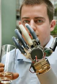 Handy: Christian Kandlbauer shows off the mind-controlled arms he drives with. A former mechanic who lost his arms in an industrial accident four years ago ... - article-0-0728DC83000005DC-69_233x344