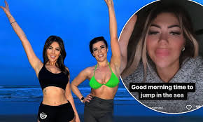Chloe Ferry shows off her toned abs in crop top as she swims in freezing 
sea...