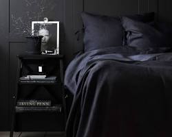 dark bedroom with a comfortable bed