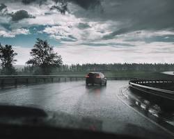 Image of car driving on a rainy road