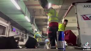 Baggage handlers filmed throwing luggage at airport stood down pending 
investigation