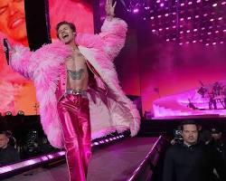 Harry Styles in a neon pink feathered dress