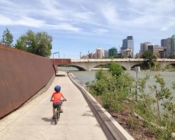 person biking on the Bow River Pathway
