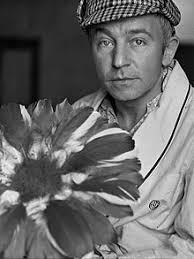 Henry Gibson with his trademark flower. For three seasons on Laugh-In, Gibson delivered simple-minded poems in a southern drawl while clutching a giant ... - henry_gibson_1491489f