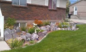 Terraced rock flowerbeds with concrete mowstrip | Side yard ...
