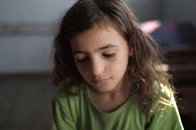 Displaced Palestinian Yasmine Omar Al Attar, 10, sits at a U.N. school where the - girl