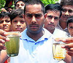 Residents show contaminated water at Vikas Nagar in Chandigarh on Monday. Tribune Photos: Nitin Mittal - chd18