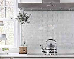 Glass tile backsplash in white kitchen
