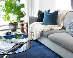 Image of bluethemed living room with various shades of blue in furniture, pillows, and throws