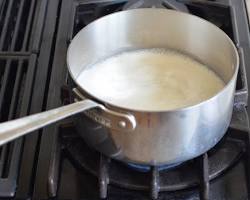 saucepan of heavy cream being heated over medium heat